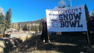 T. Tracy holding a banner at Snowbowl